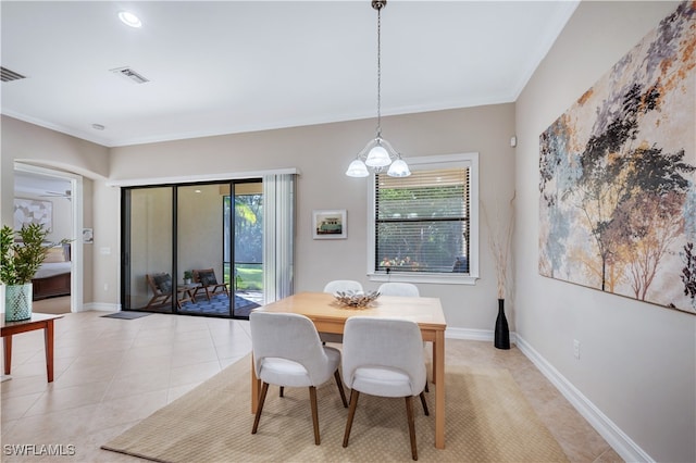 tiled dining area with crown molding and a chandelier