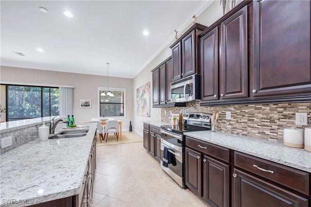 kitchen with tasteful backsplash, sink, hanging light fixtures, stainless steel appliances, and crown molding