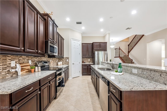 kitchen featuring decorative backsplash, appliances with stainless steel finishes, light stone countertops, ornamental molding, and sink