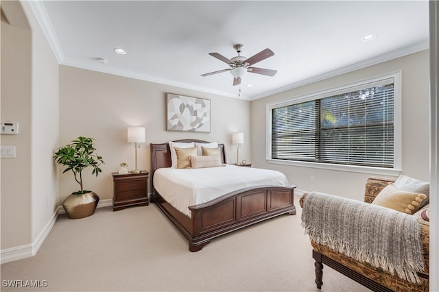 carpeted bedroom featuring ornamental molding and ceiling fan