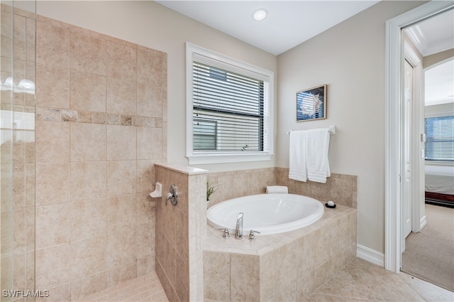 bathroom featuring shower with separate bathtub and tile patterned flooring