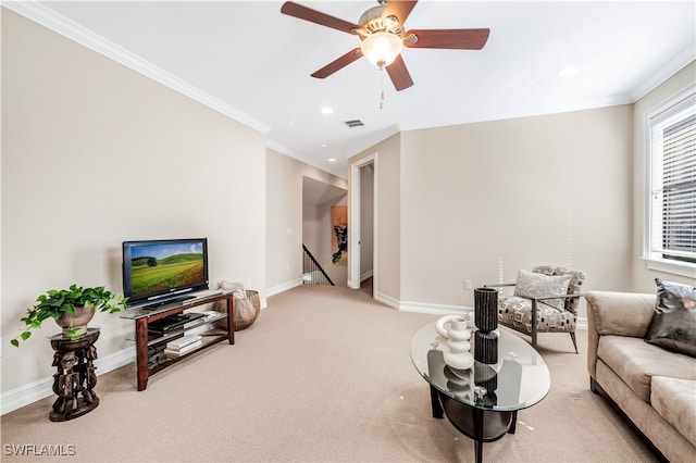 living room with crown molding, carpet flooring, and ceiling fan