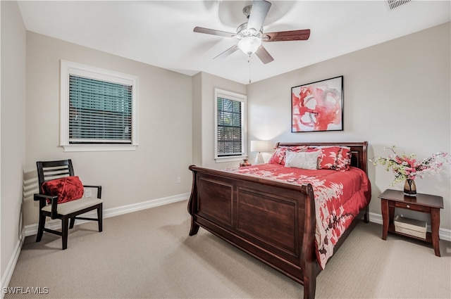 bedroom with light carpet and ceiling fan