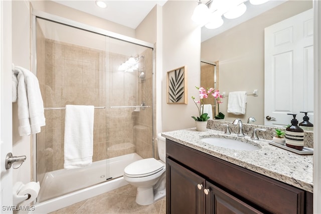 bathroom with vanity, walk in shower, toilet, and tile patterned floors