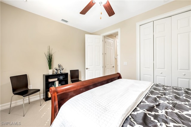 carpeted bedroom with a closet and ceiling fan