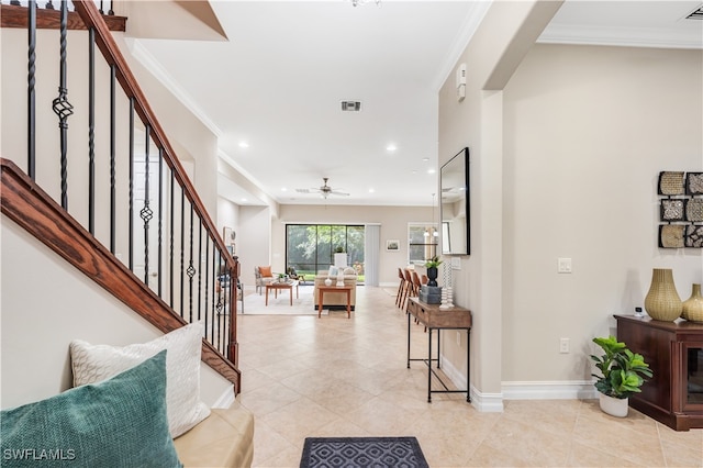 foyer featuring ceiling fan, ornamental molding, and light tile patterned floors