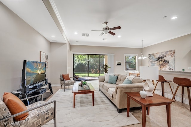 living room with crown molding and ceiling fan with notable chandelier