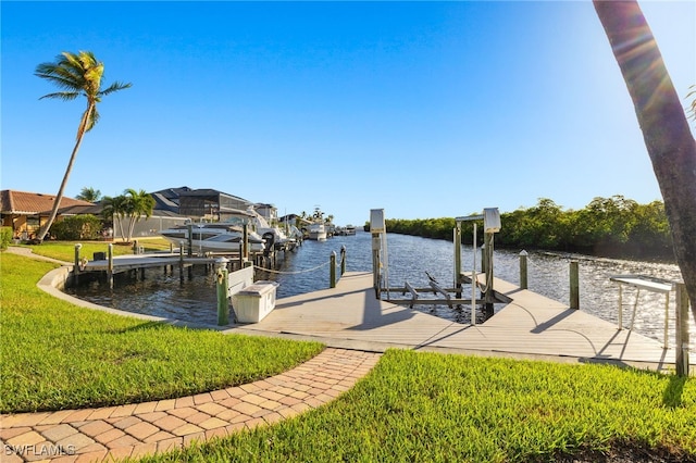 dock area with a water view and a lawn