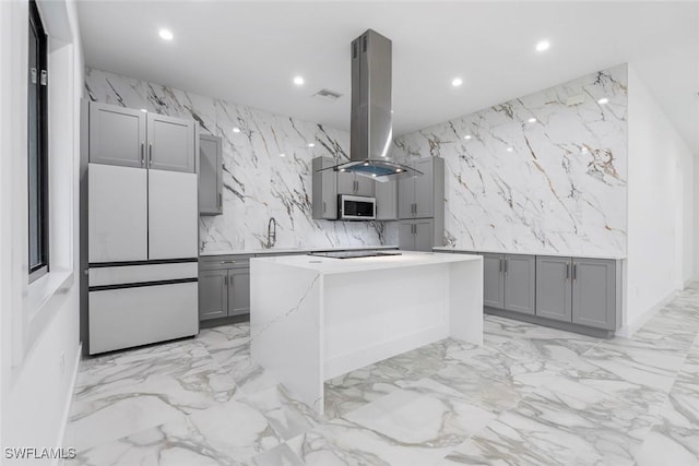 3421 16th Ave NE, Naples, FL 34120 - kitchen featuring fridge, gray cabinetry, island range hood, and recessed lighting