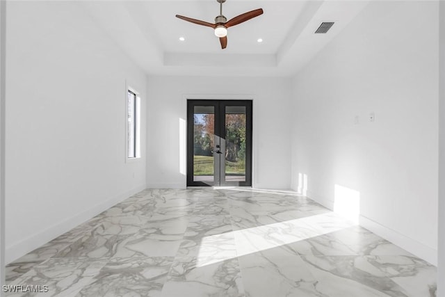 3421 16th Ave NE, Naples, FL 34120 - empty room with a ceiling fan, visible vents, baseboards, a tray ceiling, and recessed lighting