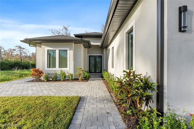 3421 16th Ave NE, Naples, FL 34120 - property entrance featuring french doors and stucco siding