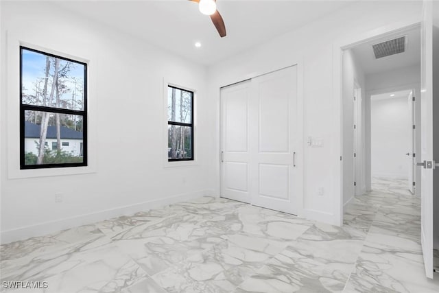 3421 16th Ave NE, Naples, FL 34120 - unfurnished bedroom with baseboards, visible vents, and multiple windows