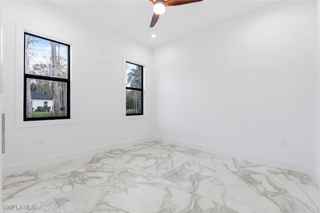 empty room featuring a healthy amount of sunlight and ceiling fan