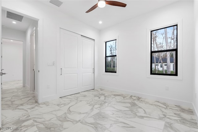 unfurnished bedroom with a closet and ceiling fan