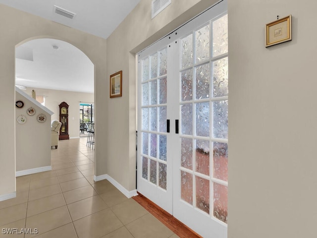 2739 Merida Ln, Cape Coral, FL 33909 - hall featuring visible vents, tile patterned floors, baseboards, and arched walkways