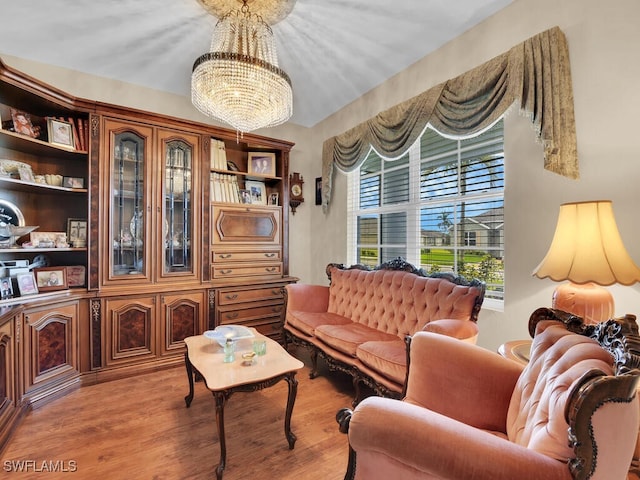 2739 Merida Ln, Cape Coral, FL 33909 - sitting room with wood finished floors and a chandelier