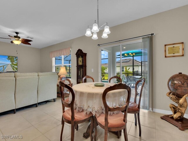 2739 Merida Ln, Cape Coral, FL 33909 - dining area featuring ceiling fan with notable chandelier, baseboards, and light tile patterned floors