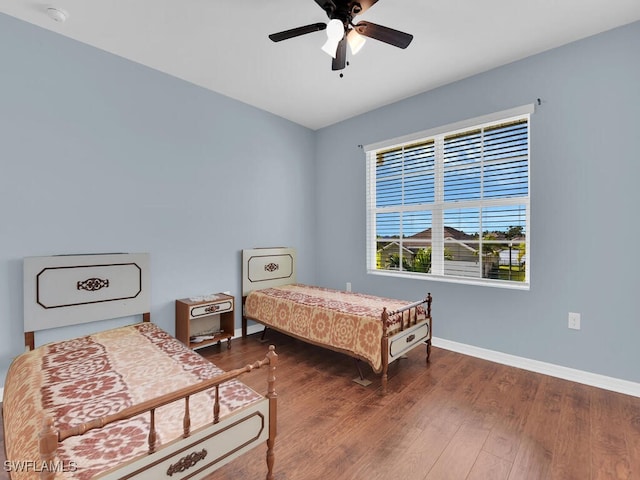 2739 Merida Ln, Cape Coral, FL 33909 - bedroom featuring wood finished floors, a ceiling fan, and baseboards