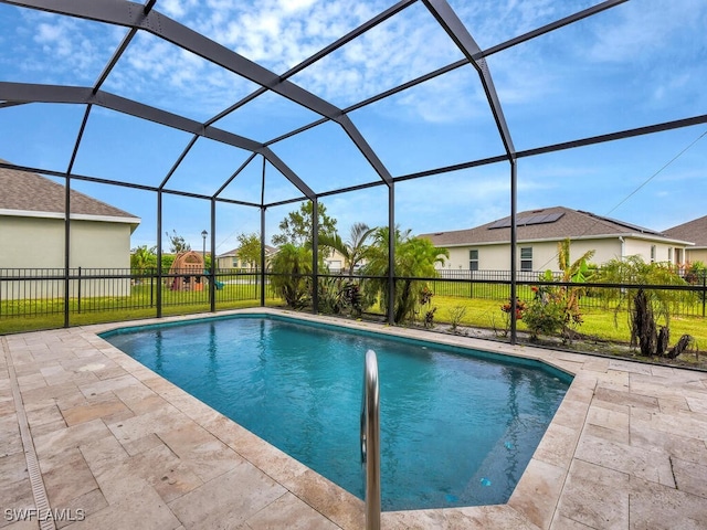 view of pool featuring a patio area, a lawn, and a lanai