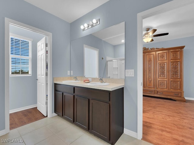 2739 Merida Ln, Cape Coral, FL 33909 - bathroom with double vanity, a shower stall, baseboards, and a sink