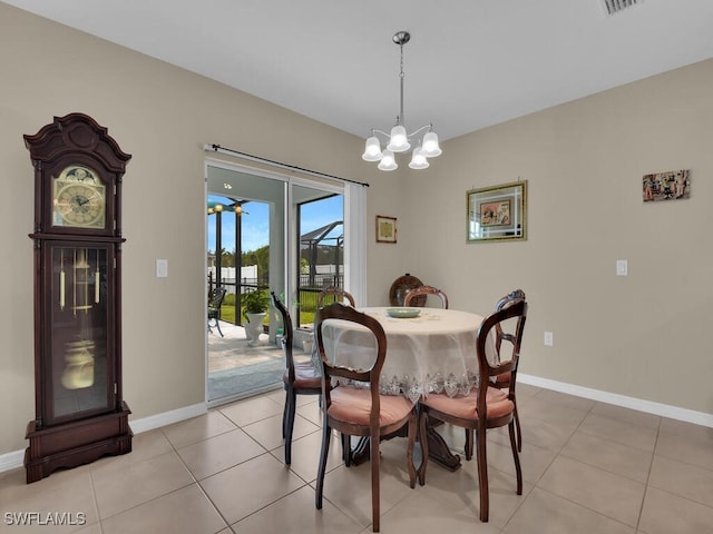 2739 Merida Ln, Cape Coral, FL 33909 - dining room featuring baseboards, a notable chandelier, and light tile patterned floors