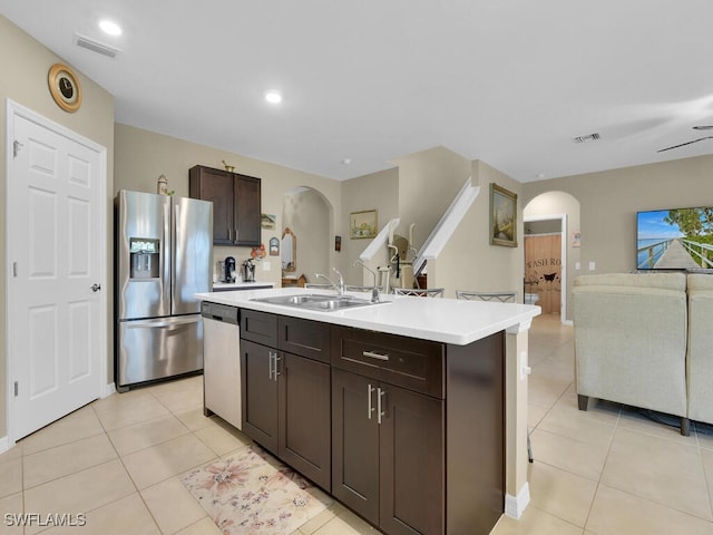 2739 Merida Ln, Cape Coral, FL 33909 - kitchen with visible vents, a sink, arched walkways, and appliances with stainless steel finishes