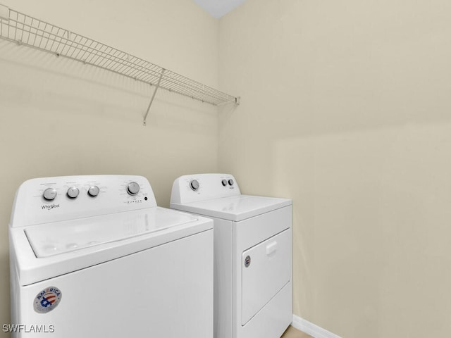 2739 Merida Ln, Cape Coral, FL 33909 - clothes washing area with washing machine and clothes dryer, laundry area, and baseboards