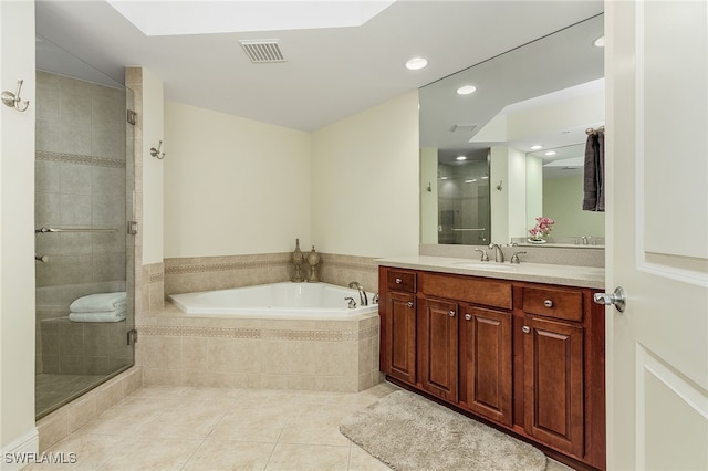 bathroom featuring vanity, tile patterned floors, and plus walk in shower