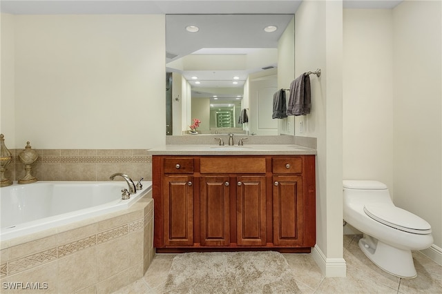 bathroom featuring vanity, toilet, tiled bath, and tile patterned flooring