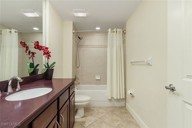 2090 W First St Unit 1609, Fort Myers, FL 33901 - bathroom featuring tile patterned flooring, vanity, shower / tub combo with curtain, toilet, and baseboards