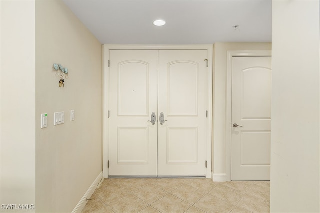 hall with light tile patterned floors