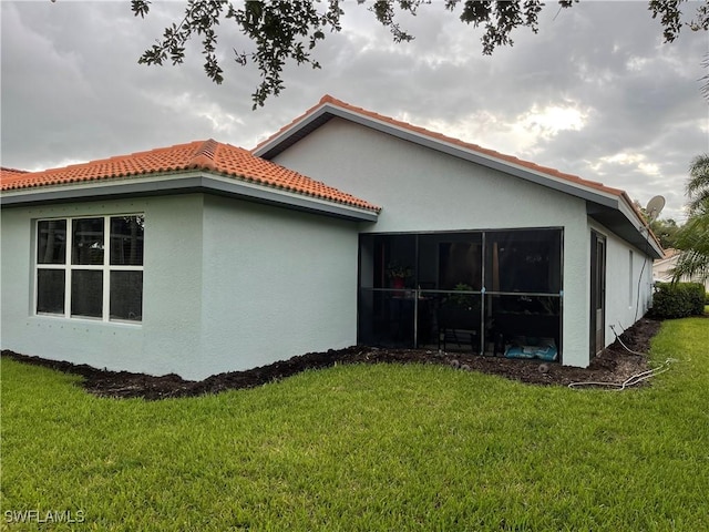 view of side of home with a yard