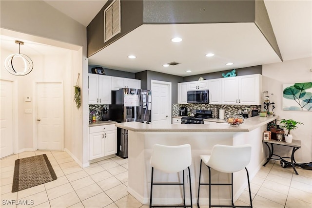 kitchen with backsplash, black appliances, kitchen peninsula, hanging light fixtures, and white cabinetry