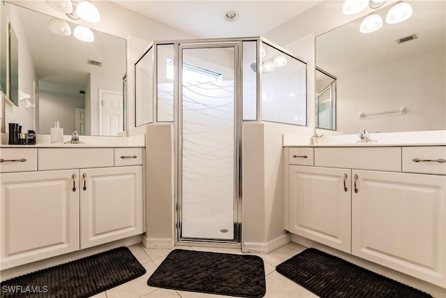 bathroom featuring tile patterned floors, vanity, and a shower with shower door