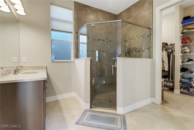 bathroom with vanity, an enclosed shower, and tile patterned floors