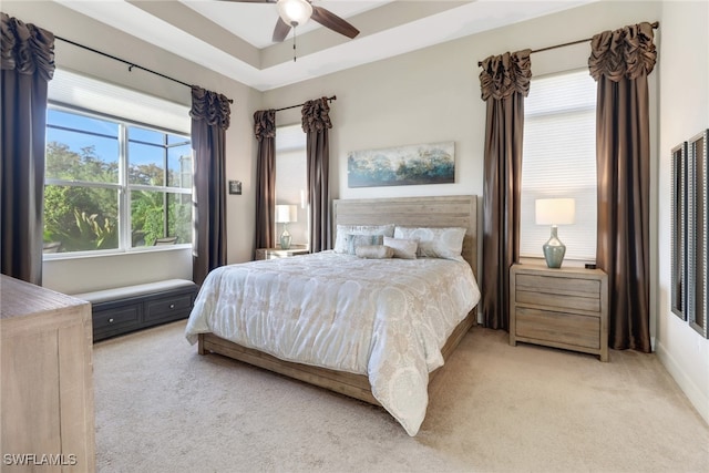 carpeted bedroom featuring multiple windows and ceiling fan