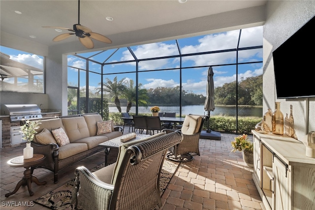 view of patio with glass enclosure, grilling area, an outdoor hangout area, exterior kitchen, and ceiling fan