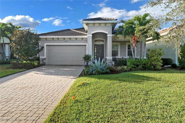 view of front of property with a garage and a front lawn