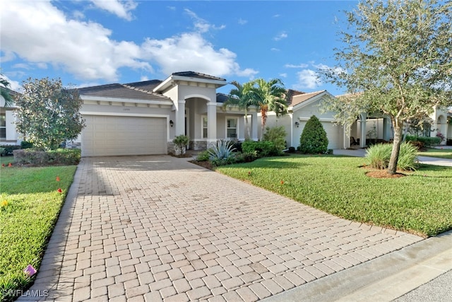 mediterranean / spanish-style house featuring a front yard and a garage