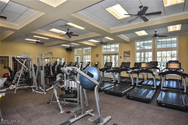 workout area featuring coffered ceiling