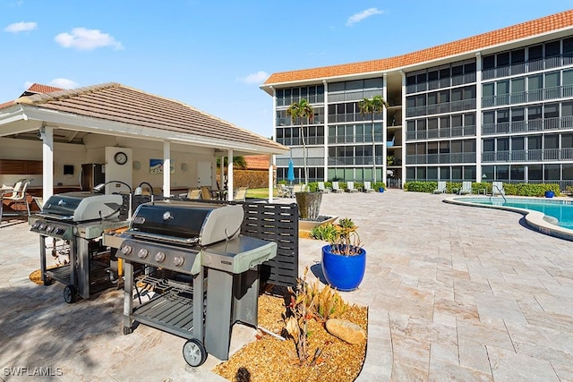 222 Harbour Dr Unit 314, Naples, FL 34103 - view of patio featuring a community pool and a grill