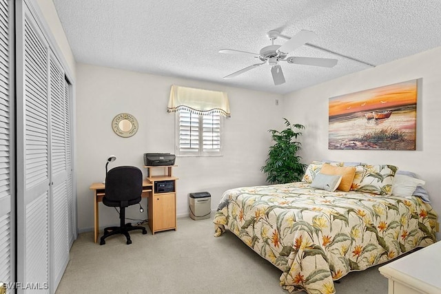 222 Harbour Dr Unit 314, Naples, FL 34103 - bedroom featuring a ceiling fan, a textured ceiling, light carpet, and a closet