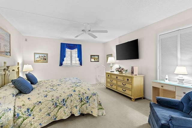 carpeted bedroom featuring a textured ceiling, a closet, and ceiling fan