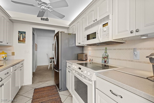 kitchen featuring white cabinets, ceiling fan, light tile patterned floors, backsplash, and white appliances