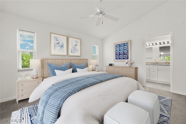 carpeted bedroom featuring ensuite bath, vaulted ceiling, and ceiling fan