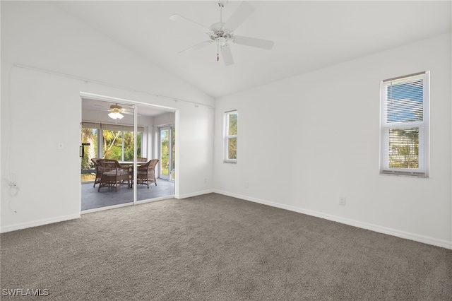 carpeted spare room with lofted ceiling, a healthy amount of sunlight, and ceiling fan