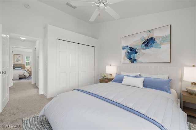 carpeted bedroom featuring a closet and ceiling fan