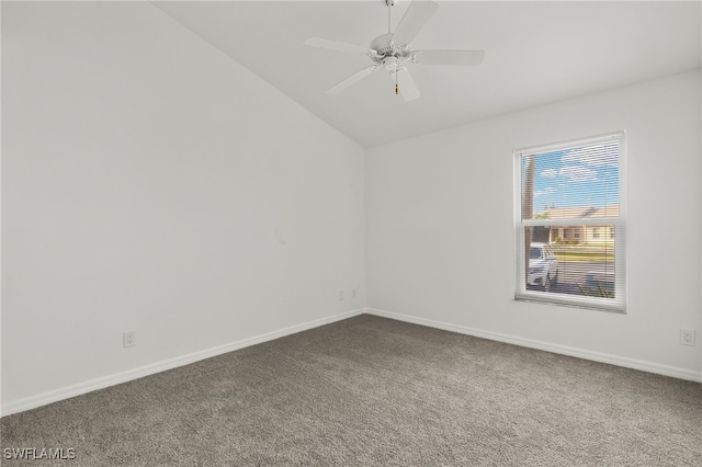 spare room featuring ceiling fan, carpet, and vaulted ceiling