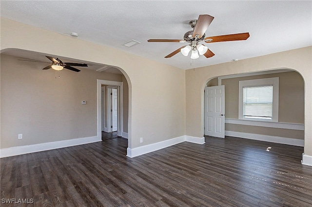 unfurnished room with a textured ceiling, ceiling fan, and dark hardwood / wood-style flooring