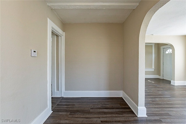 corridor with dark hardwood / wood-style floors